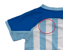 Load image into Gallery viewer, Blue and light blue sports jersey with a red circle highlighting a small defect on the white stripe.
